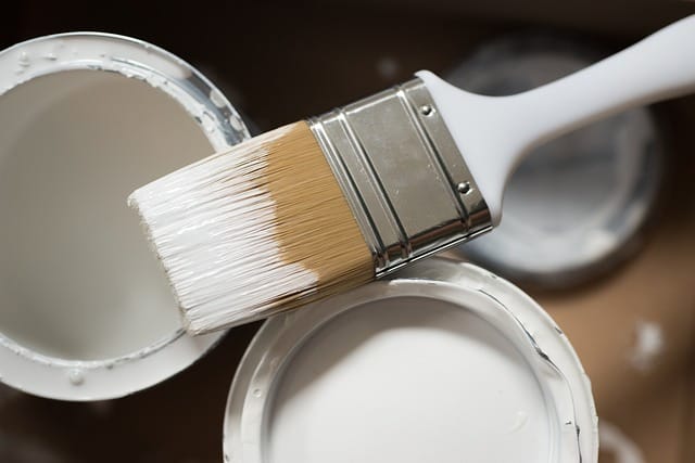 paint pots and brushes for decorating a new home