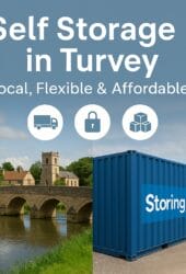 “Blue storage containers at Storing.com’s Bletsoe depot near Turvey village, Bedfordshire, with secure gated access and countryside setting”